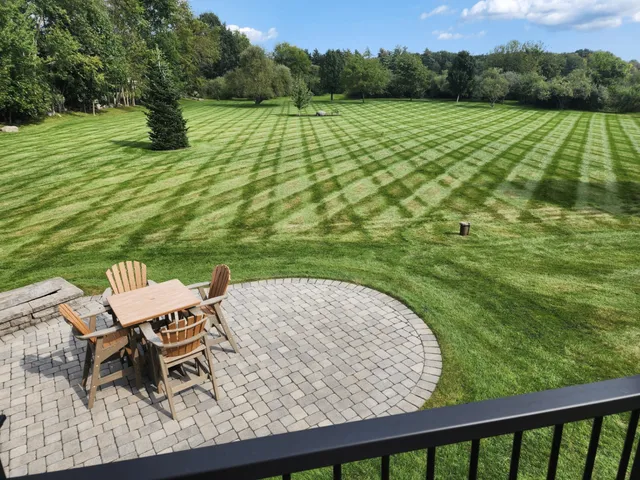 Landscaped patio with striped lawn