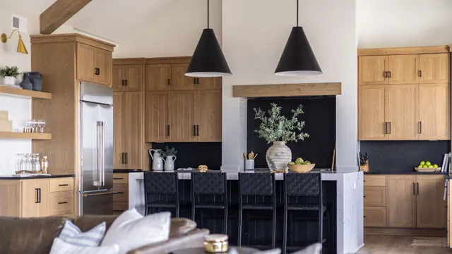 Open concept modern-rustic kitchen renovation in Portsmouth, NH with stainless steel appliances, black hardware, and wood accents