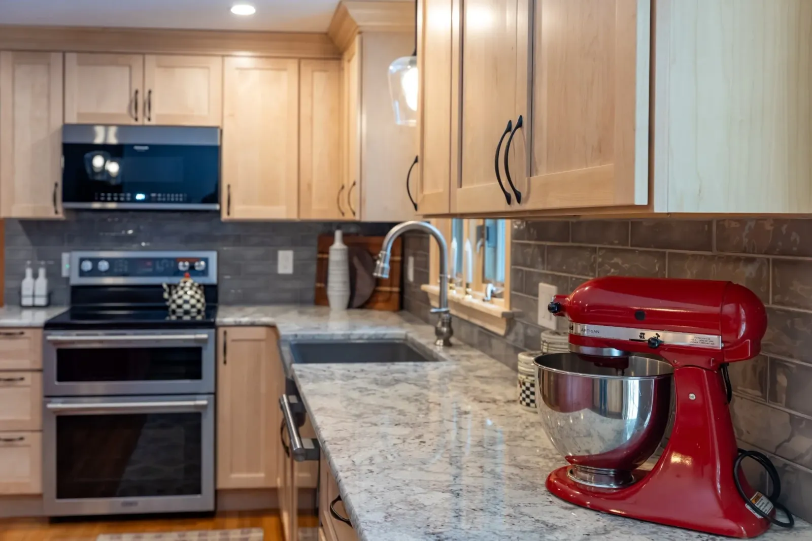 Natural Maple cabinetry with Red Appliances.