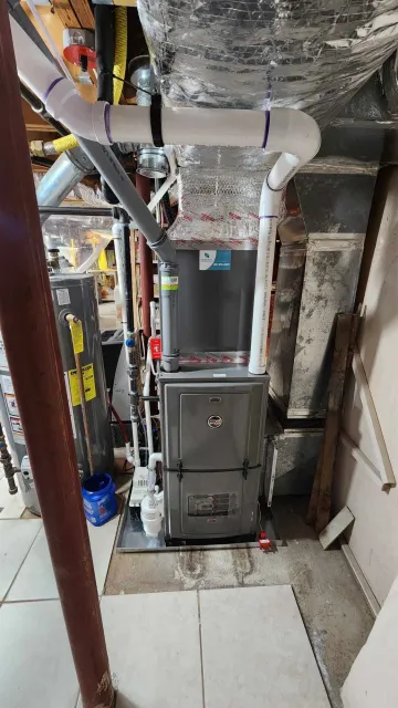 Furnace and ductwork in a utility room.
