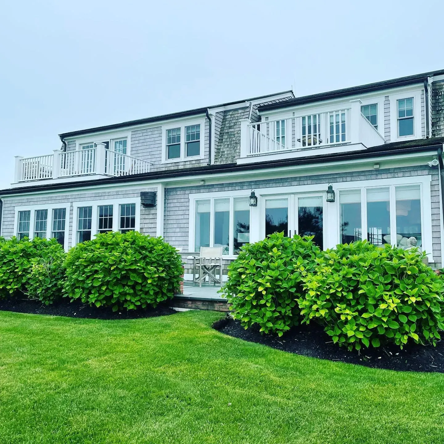 Sparkling windows on Cape Cod home with well-maintained landscaping