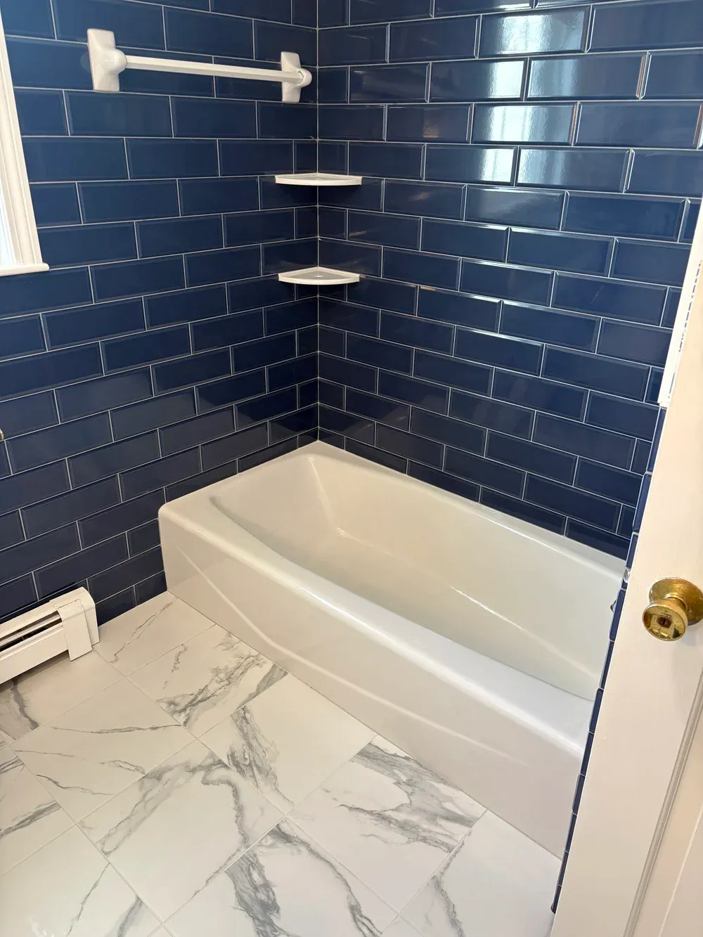 Plymouth, MA bathroom remodel with navy blue subway tile and white vanity by MSDG Construction
