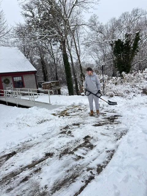 GB Landscape clearing snow from a Cape Cod driveway