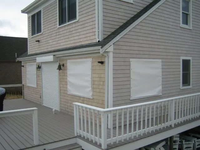 A house with white shutters and a porch.