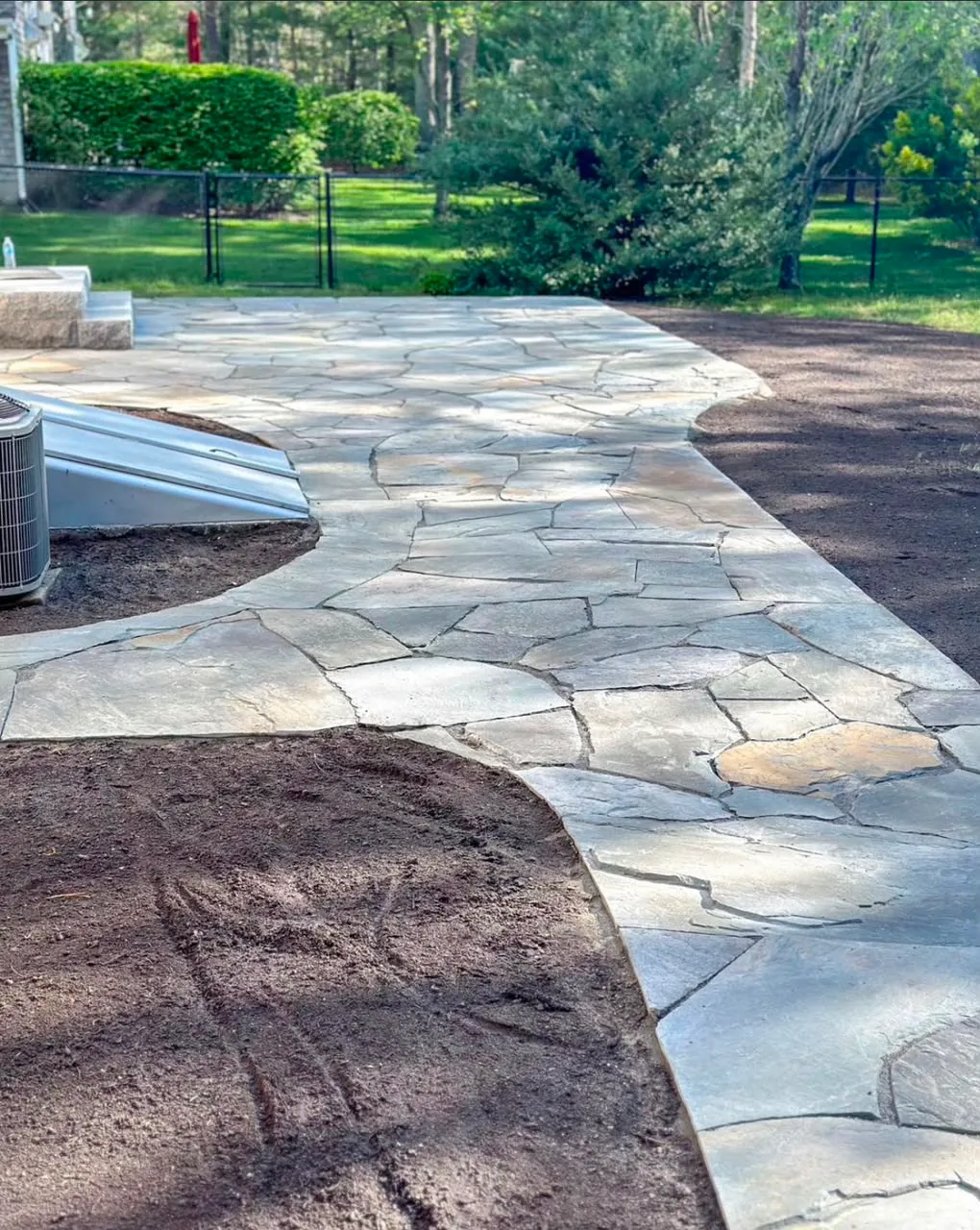 Natural stone garden path in a landscaped Cape Cod yard