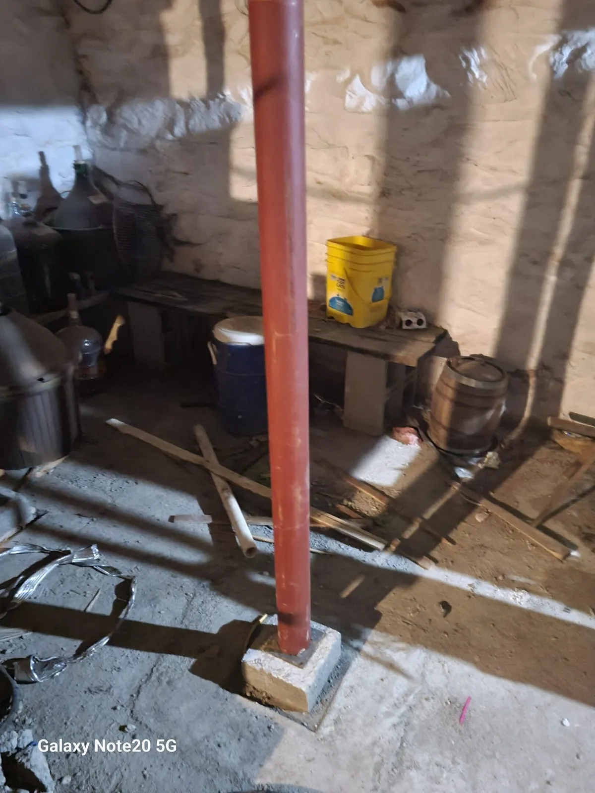 A red pole in the middle of a room.