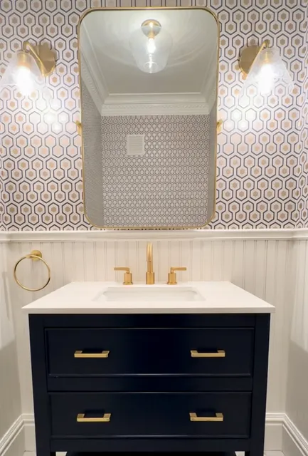 A bathroom with a sink and mirror in it