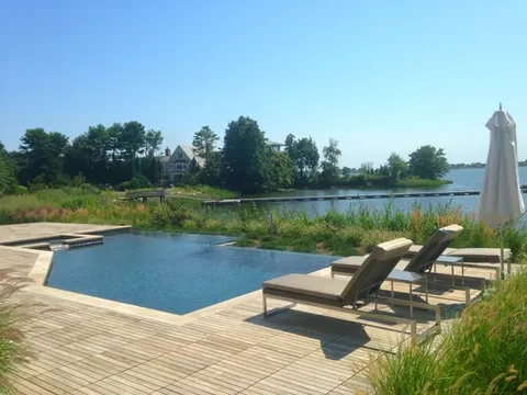 outdoor patio with fire pit and built-in seating in Connecticut home renovation