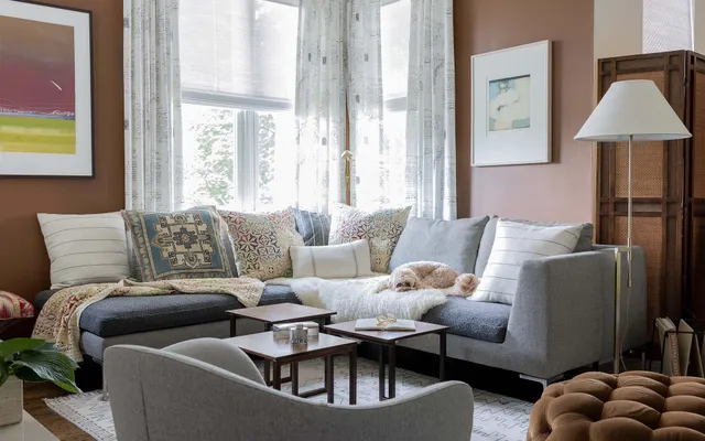 A living room filled with furniture and a dog laying on the couch