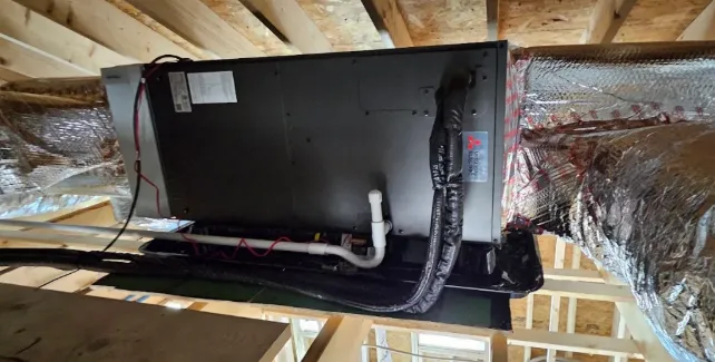 Attic air handler with insulated supply ductwork and condensate piping