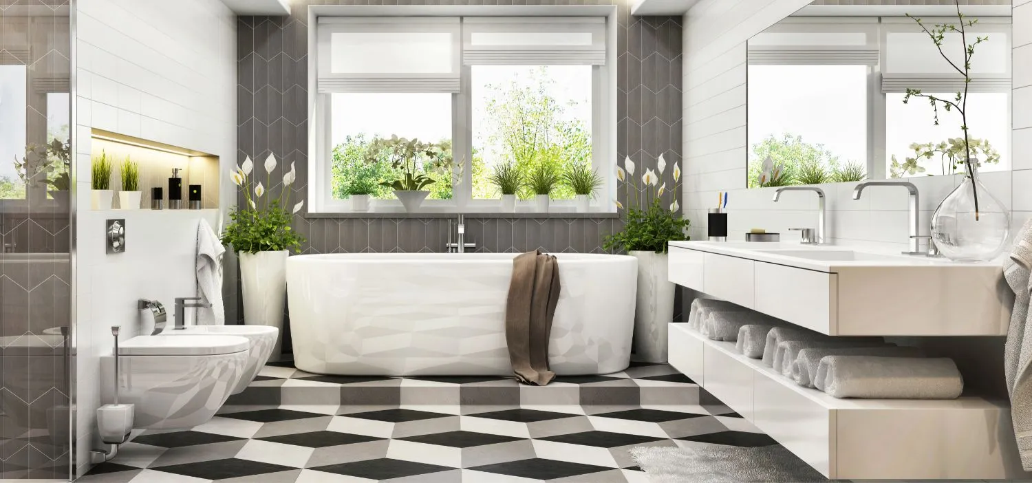 Bright, airy bathroom remodel in an NH home featuring a freestanding soaking tub, sleek double vanity, patterned tile flooring, and abundant natural light.
