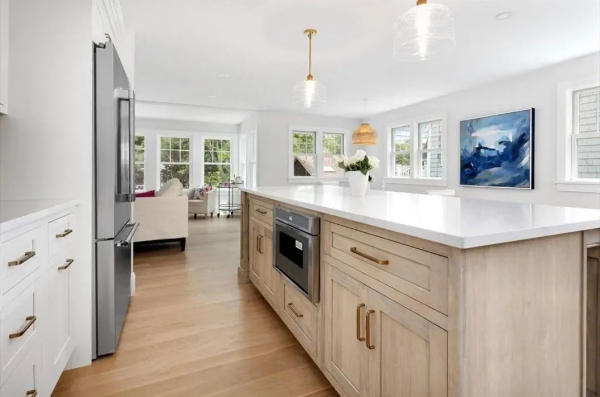 A kitchen with a large island and stainless steel appliances.