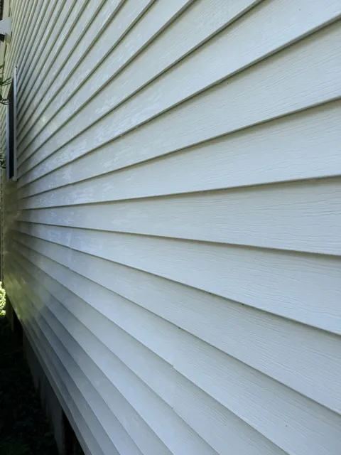 Clean green clapboard siding after Eagle's soft wash