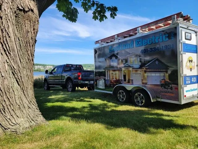 Eastland Electric truck with trailer in front of a pond in Rhode Island
