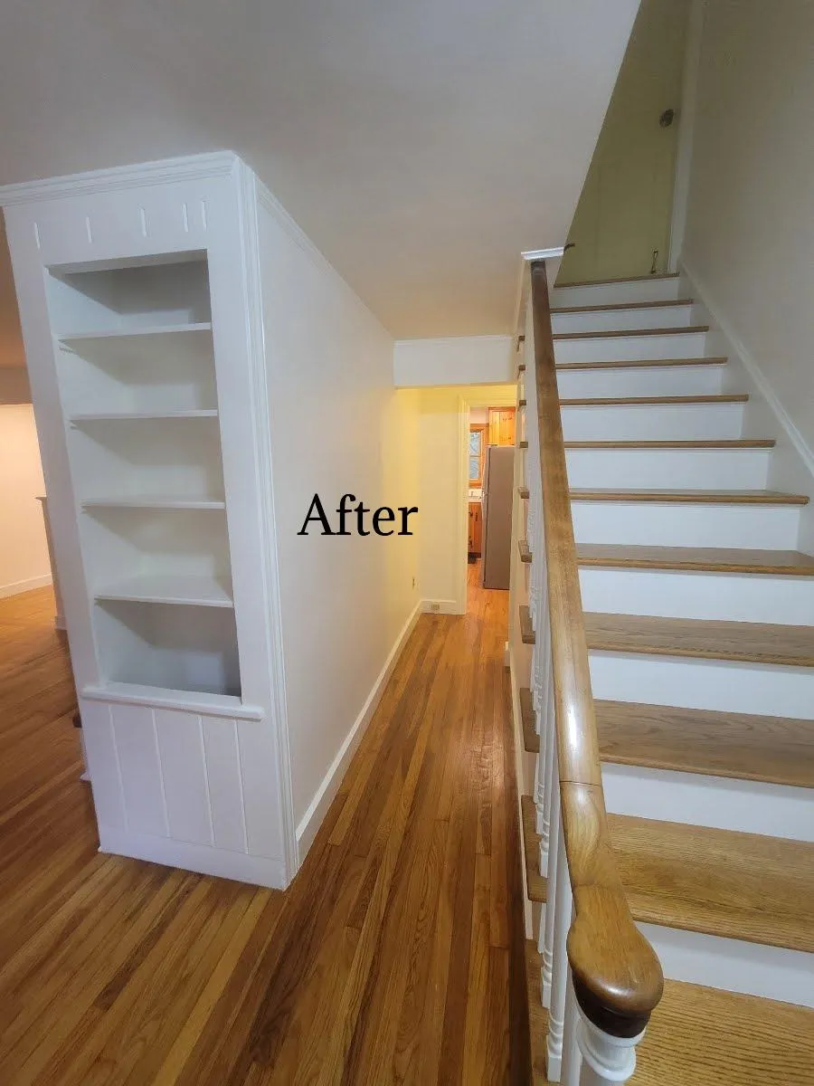 A freshly painted front hallway with bright white walls, making the space feel more lively and vibrant, painted by Impeccable Painting.