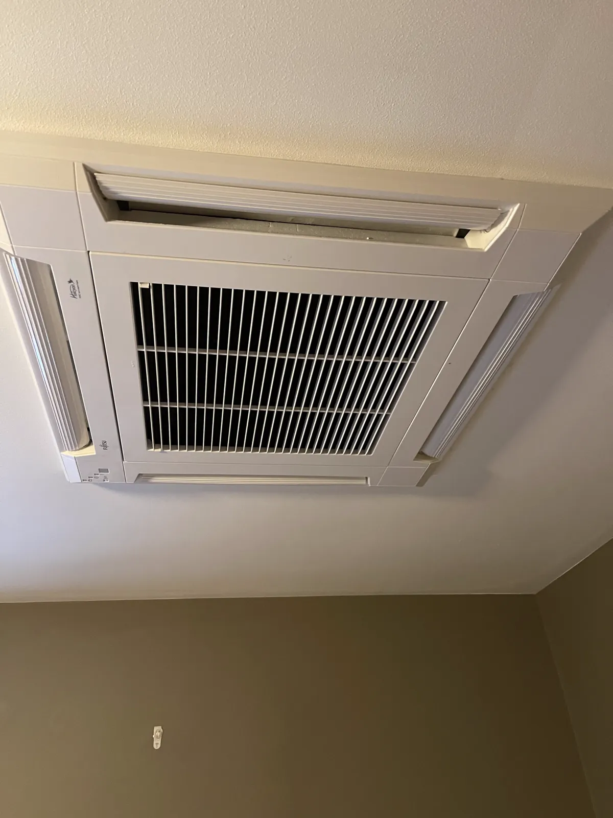 Ceiling-cassette heat pump head on a whole-home install
