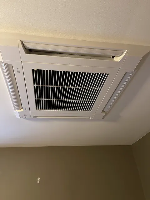 Ceiling-cassette heat pump head on a whole-home install