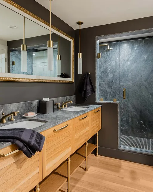 A bathroom with two sinks and a shower