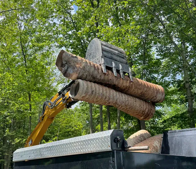 Heavy recycling debris being loaded into a Junkit truck during a removal project in Charlotte