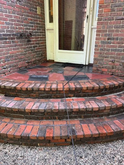 Brick front steps and landing after cleaning and repair
