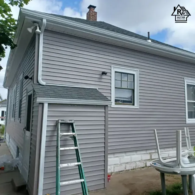 A ladder is leaning against the side of a house