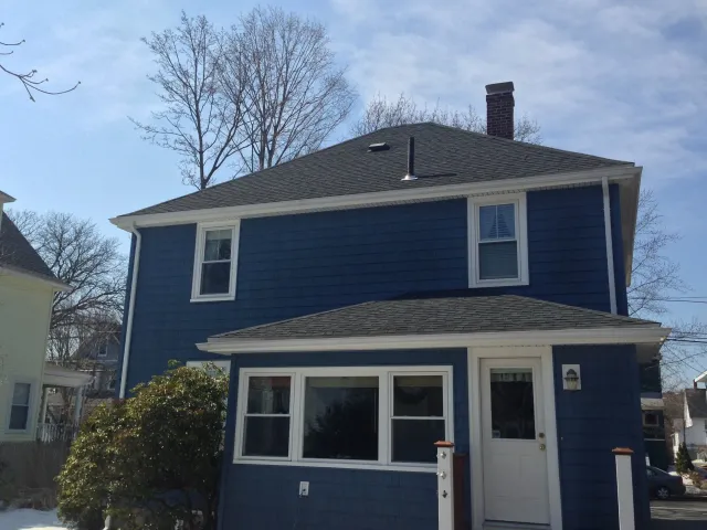A blue house with a white door and windows