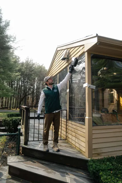 Tanner spraying home trim