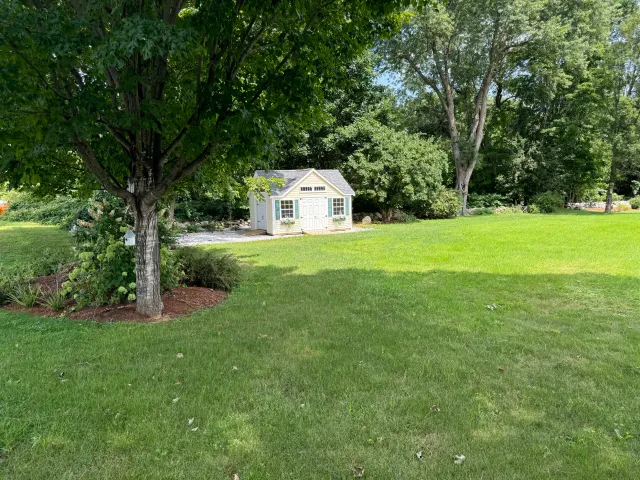 Lawn mowing and trimming service in Groton, MA neighborhood by Gardner’s Landscaping, LLC