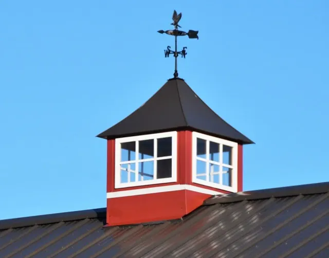 Sheet metal with weathervane on top.