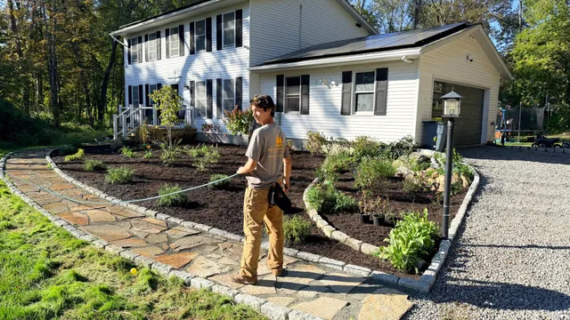 Curved flagstone walkway with new planting beds and mulch
