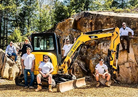 The GSM crew with one of their mini excavators