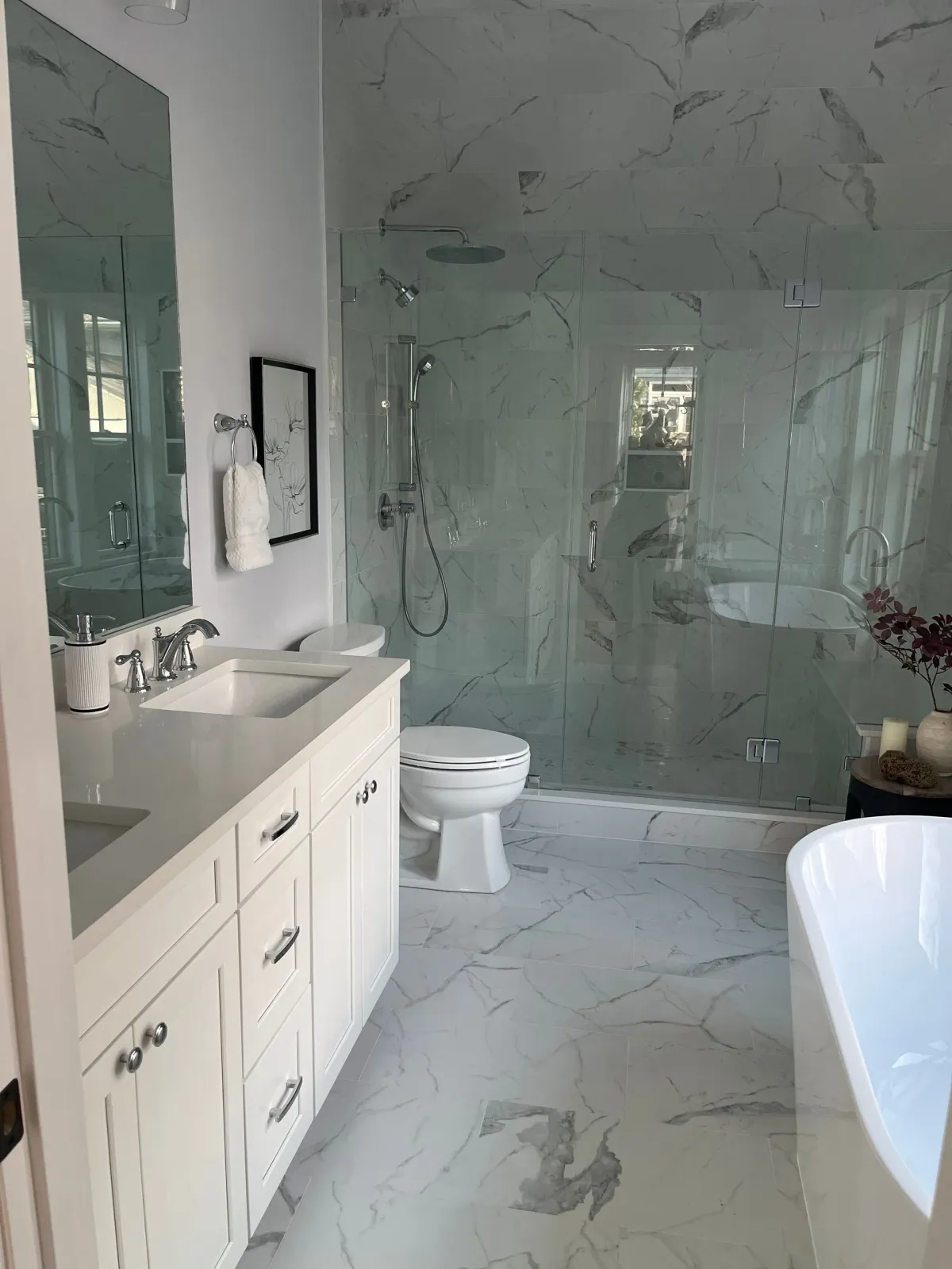 A bathroom with a sink, toilet, shower and bathtub.