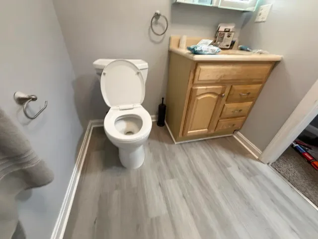Completed gray wood-look bathroom flooring in Providence Rhode Island
