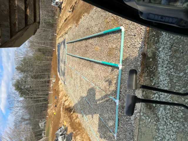 Gravel driveway with crushed stone base and drainage marking lines