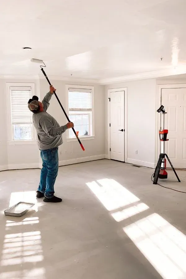 Handyman completing interior paint services for home remodel in Norfolk, Massachusetts.