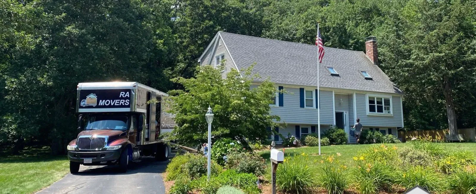 RA Mover's box truck parked in the driveway of a home
