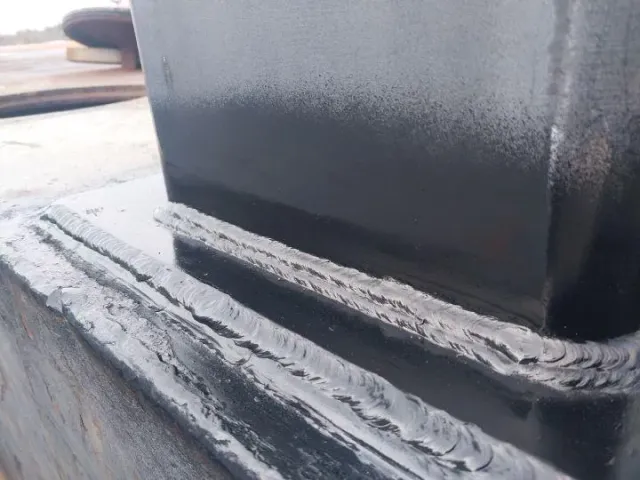 Detailed view of strong steel weld bead on industrial component, showcasing precision welding technique by Warrior Welding