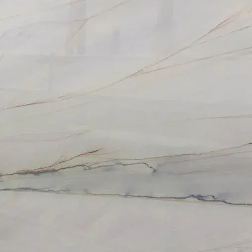 Close-up of a marble surface with light gray and subtle brown and gold veining.