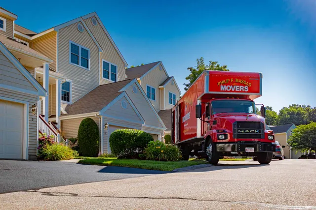 A moving truck parked in front of a house.