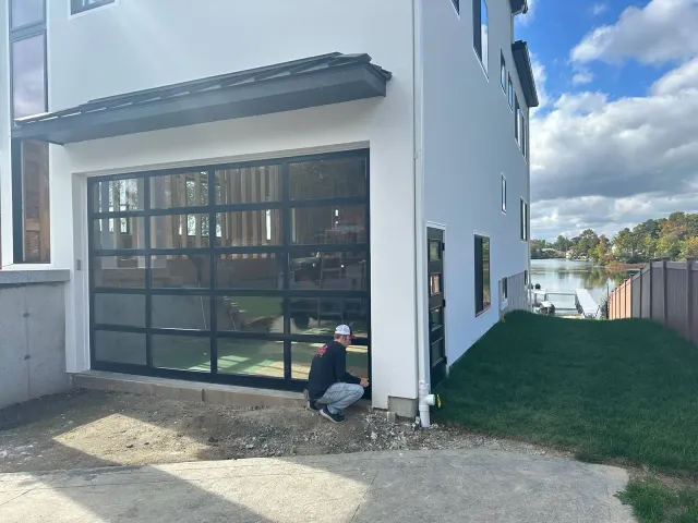 Setting a full-view glass door on a new lakeside build