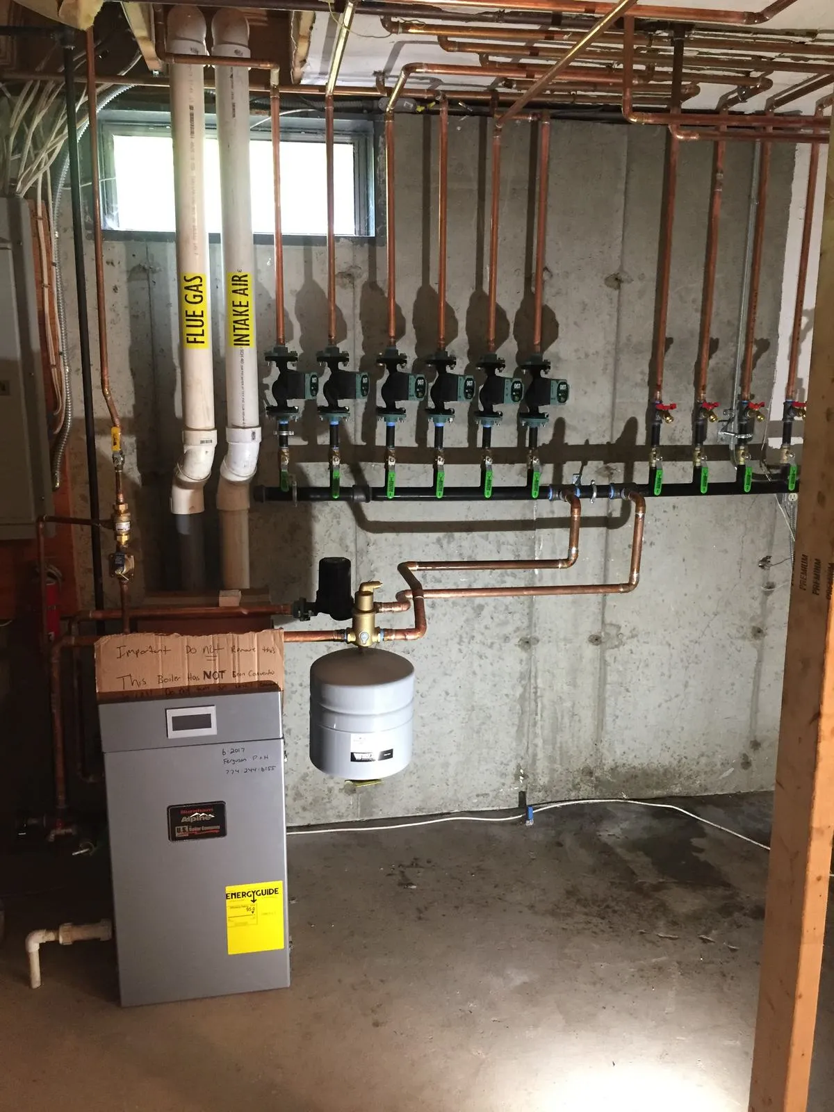 Six-zone copper Taco manifold installed on a condensing boiler by Ferguson Plumbing Design