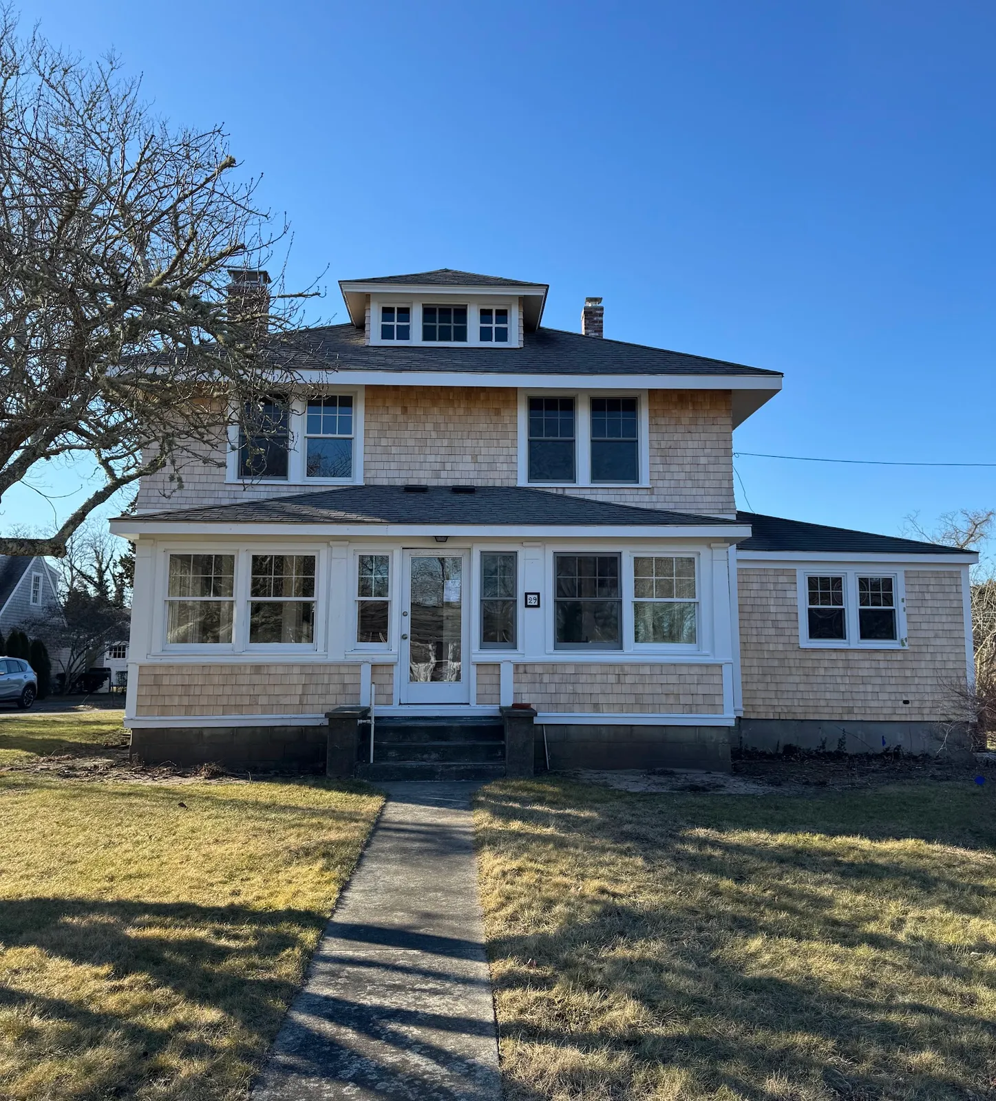 Cedar-shingled hip-roof home after exterior restoration