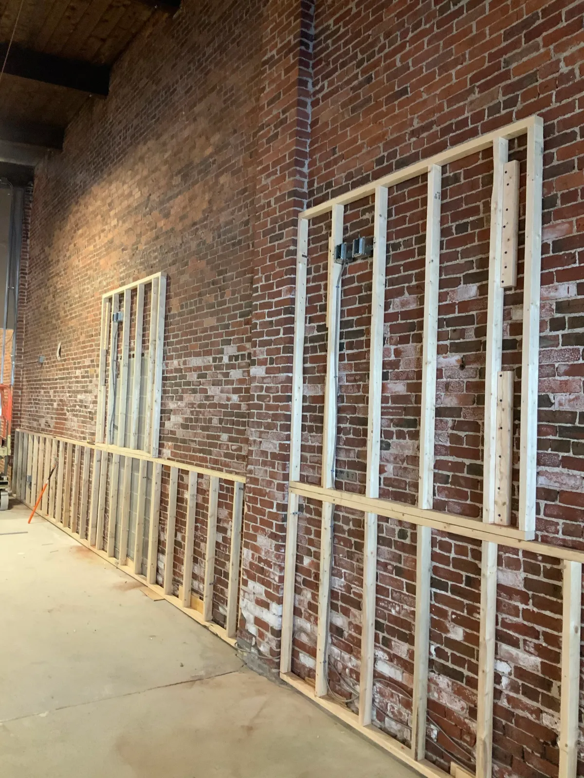 Brick wall with wooden framing for construction
