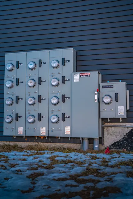 Multi-unit residential electric meter bank installation on exterior wall
