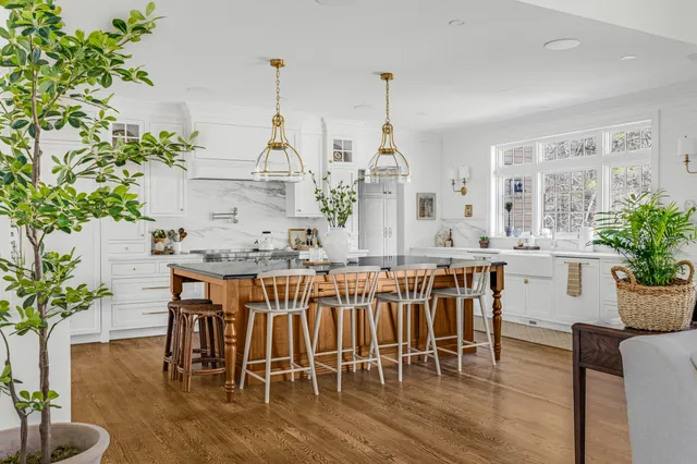 Timeless Norwell kitchen with white Mouser inset cabinetry, wood island, custom hood, and brass hardware