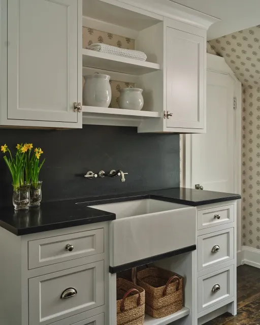 Laundry rooms deserve great design too🧺

The full-height soapstone backsplash in this space makes a bold statement, the rich color is the perfect backdrop to let the wall-mounted faucet shine. Conrad carried thoughtful details from room to room in t