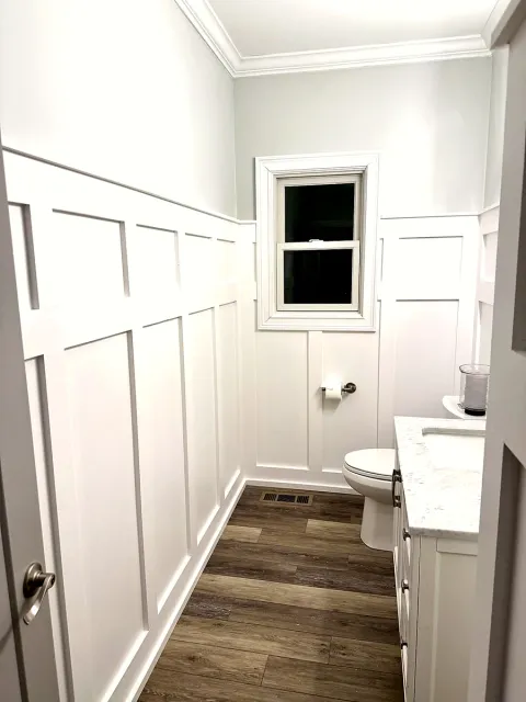 Bathroom wall finished with painted board and batten trim work