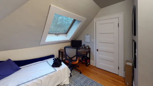 Attic bedroom with new skylight and refinished floors