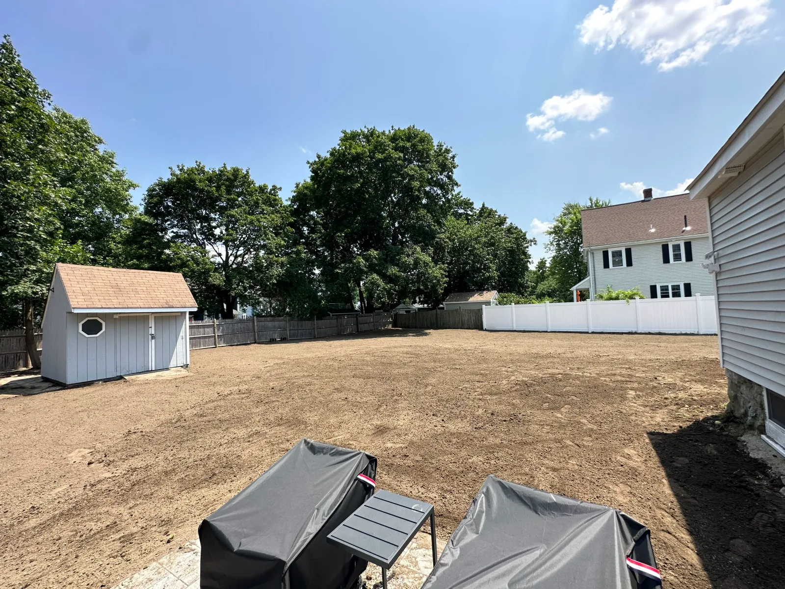Yard regraded and fenced ahead of hardscape work