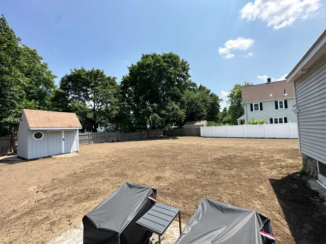 Yard regraded and fenced ahead of hardscape work